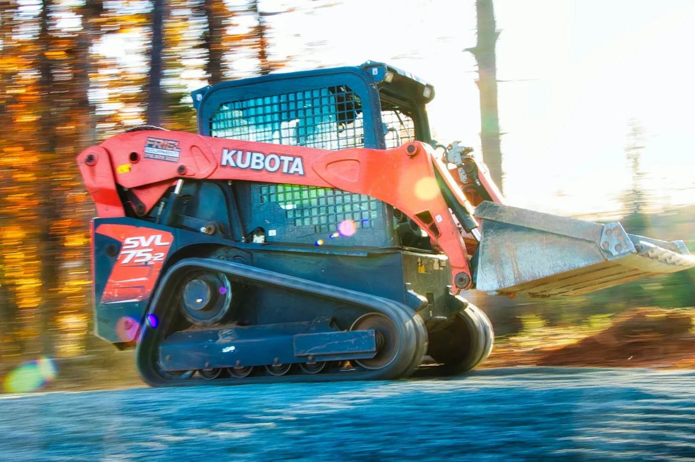 Compact tracked loader in an outdoor equipment scene
