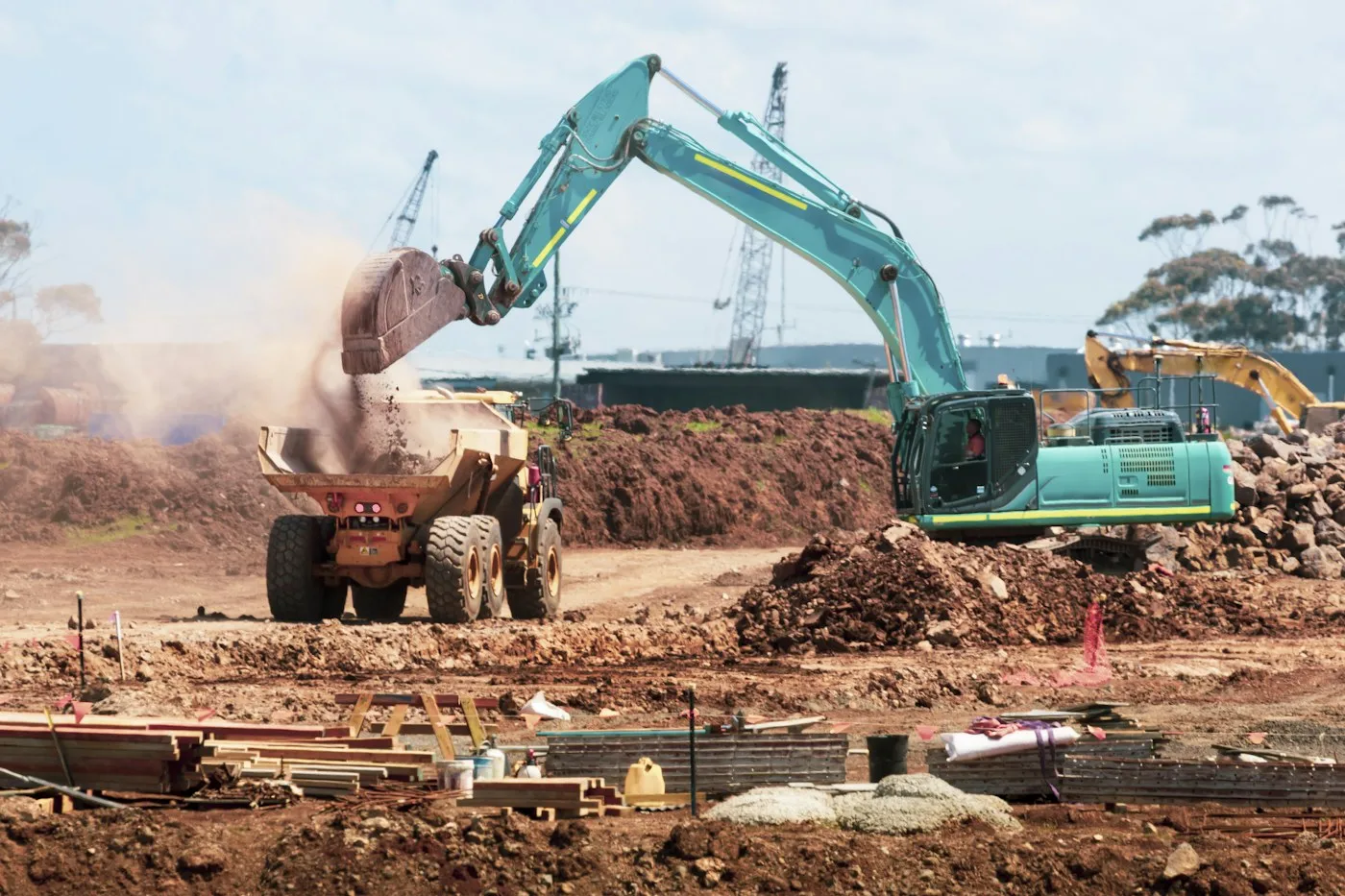 Excavator loading soil into a truck