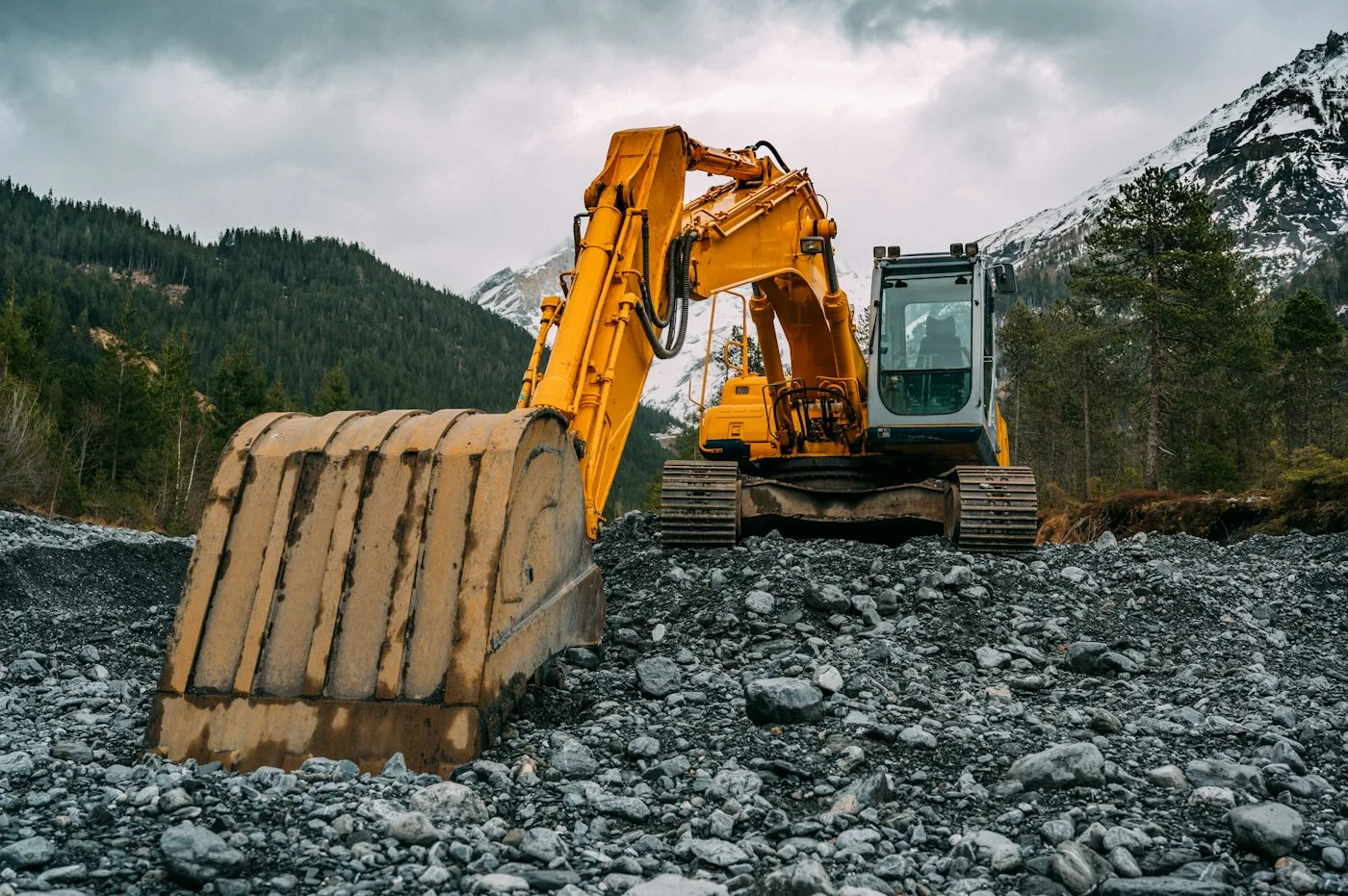 Tracked excavator and bucket on a mountain worksite